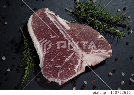 Raw T-Bone Steak on Granite Surface. Fresh Uncooked T-Bone Steak on Stone Background. 138732610