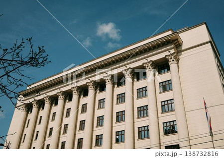 Large neoclassical government building with tall columns and Serbian flag in Belgrade. Concept of authority, stability and institutional architecture 138732816