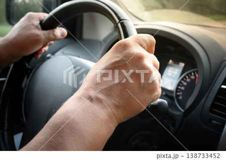 Hands on steering wheel driving car close up transport concept Hands on steering wheel driving car close up transport concept 138733452