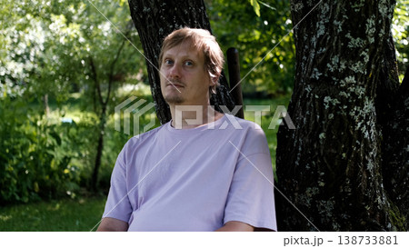 Relaxing man in a park on a bench in summer, enjoying the fresh air, vacation, or relaxing alone in the garden. A thoughtful, smiling, or calm man in nature, resting or waiting in a natural setting. Relaxing man in a park on a bench in summer, enjoying the fresh air, vacation, or relaxing alone in the garden. A thoughtful, smiling, or calm man in nature, resting or waiting in a natural setting. 138733881