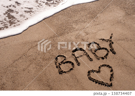 Baby writ on a sand. Baby written in the sand on the beach. Baby writ on a sand. Baby written in the sand on the beach. 138734407