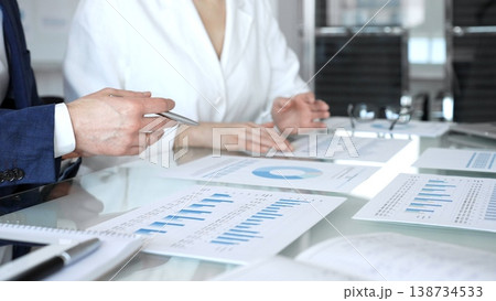 Business executive hands on contract paper with pen, preparing to sign an agreement during a meeting, representing corporate deal negotiation and legal process 138734533