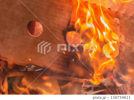 Burning cardboard boxes red-orange flame, paper waste, recycling closeup 138734611