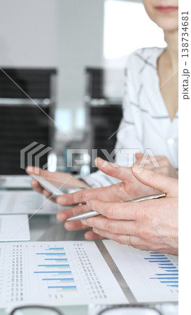 Business person's hands holding a pen, reviewing and signing a legal contract or agreement document during an important office meeting, finalizing a deal Business person's hands holding a pen, reviewing and signing a legal contract or agreement document during an important office meeting, finalizing a deal 138734681