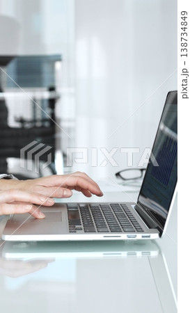 Hands expertly typing on a laptop keyboard, a professional working on important business tasks and digital communication in a modern, clean office environment Hands expertly typing on a laptop keyboard, a professional working on important business tasks and digital communication in a modern, clean office environment 138734849