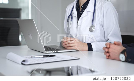 Doctor consulting patient, discussing medical information, using laptop for diagnosis and healthcare data management. Medicine, healthcare and science concept Doctor consulting patient, discussing medical information, using laptop for diagnosis and healthcare data management. Medicine, healthcare and science concept 138735026