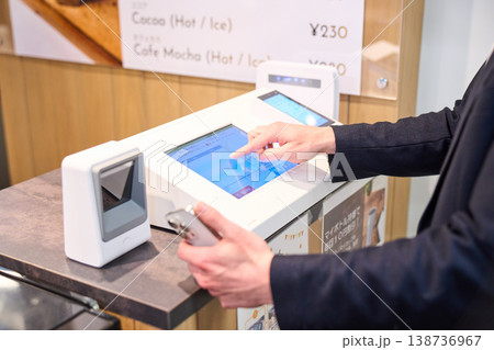 社内カフェのセルフレジでスマホ決済を利用する外資系企業のSEの手元 社内カフェのセルフレジでスマホ決済を利用する外資系企業のSEの手元 138736967