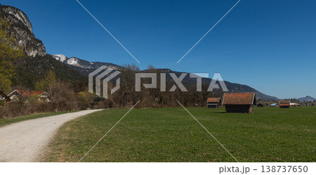 Curving Gravel Path and Rustic Huts in Bavarian Meadow Curving Gravel Path and Rustic Huts in Bavarian Meadow 138737650