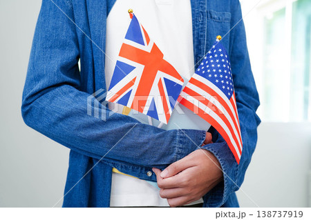 Learn English language, Asian teenage student hold book with flag in course at school. Learn English language, Asian teenage student hold book with flag in course at school. 138737919