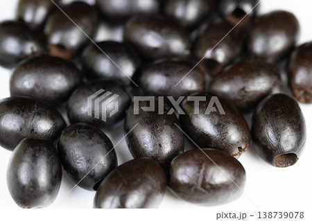 Closeup of luscious black olives. Vivid image showcasing ripe olives with sheen. Detailed portrayal of dark olives highlighting rich texture and attractive surface gloss Closeup of luscious black olives. Vivid image showcasing ripe olives with sheen. Detailed portrayal of dark olives highlighting rich texture and attractive surface gloss 138739078