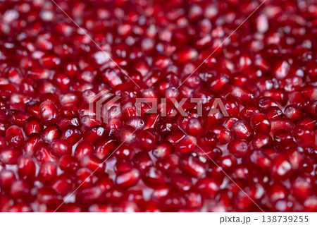 Festive ruby adornments. Seasonal holiday decorations with vibrant arils shine. Festive pomegranate seeds with reflective highlights enhance seasonal dinner table decor 138739255
