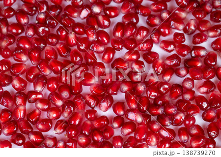 Vivid seed embellishment. Colorful pomegranate seed display. Glossy arils arranged in mosaic pattern. Bright pomegranate seeds decorate dish with vibrant contrast Vivid seed embellishment. Colorful pomegranate seed display. Glossy arils arranged in mosaic pattern. Bright pomegranate seeds decorate dish with vibrant contrast 138739270
