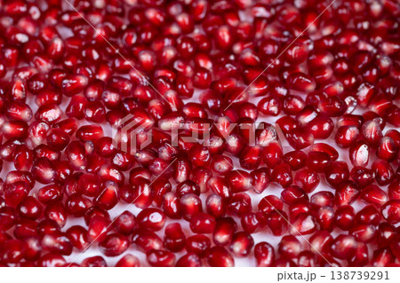 Pomegranate seeds with visible juice droplets, dynamic closeup showing wet sheen and refreshing texture, beverage and mixology inspiration, organic freshness captured in motion Pomegranate seeds with visible juice droplets, dynamic closeup showing wet sheen and refreshing texture, beverage and mixology inspiration, organic freshness captured in motion 138739291