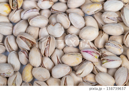 Pistachio shells with green accents. Detailed image of pistachio shells with green kernels. Seamless pattern featuring pistachio shells with green nuts and soft beige tones Pistachio shells with green accents. Detailed image of pistachio shells with green kernels. Seamless pattern featuring pistachio shells with green nuts and soft beige tones 138739637
