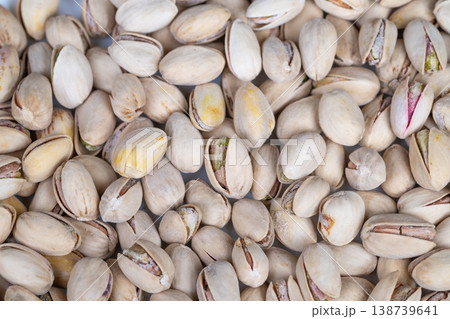 Premium pistachio shells showcase refined culinary visuals. Refined gourmet presentation highlighting intricate shell cracks and subtle hues of premium pistachio kernels Premium pistachio shells showcase refined culinary visuals. Refined gourmet presentation highlighting intricate shell cracks and subtle hues of premium pistachio kernels 138739641