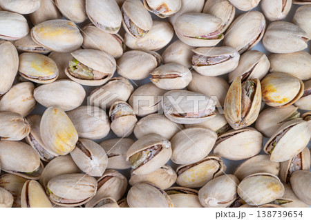 Market arrangement of pistachios emphasizes abundance and visual appeal. Display of pistachios with open and closed shells demonstrates retail variety and attractiveness Market arrangement of pistachios emphasizes abundance and visual appeal. Display of pistachios with open and closed shells demonstrates retail variety and attractiveness 138739654