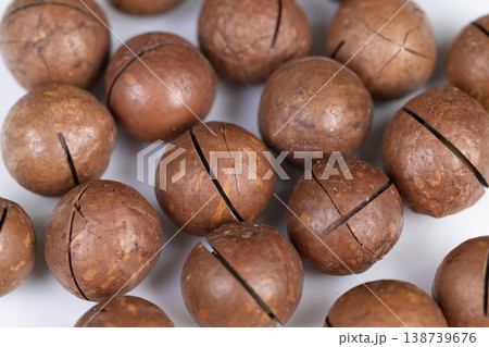 Photographic depiction of shelled nuts with rustic harvest appeal. Evoking seasonal harvest ambiance through tactile and visual representation of macadamia shells Photographic depiction of shelled nuts with rustic harvest appeal. Evoking seasonal harvest ambiance through tactile and visual representation of macadamia shells 138739676