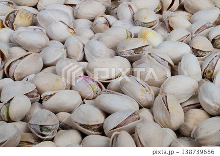 Geometric layout of pistachio shells and kernels for branding. Background featuring natural textured pistachio shells and nuts arranged in geometric style for branding purposes Geometric layout of pistachio shells and kernels for branding. Background featuring natural textured pistachio shells and nuts arranged in geometric style for branding purposes 138739686
