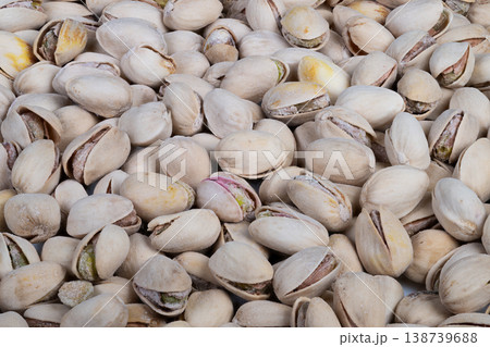 Minimalist pistachios background with even shell coverage, neutral palette and consistent pattern ideal for packaging mockups, social media banners and product labels Minimalist pistachios background with even shell coverage, neutral palette and consistent pattern ideal for packaging mockups, social media banners and product labels 138739688