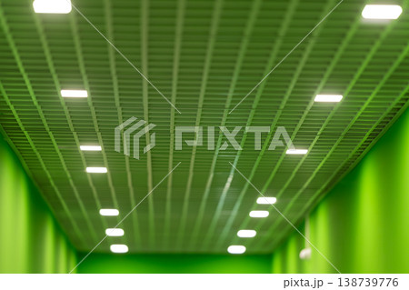 Colorful wellness corridor. Luminous limecolored path. Contemporary health zone with vibrant lighting. Symmetrical interior showcasing lively walls and calming lighting effects 138739776