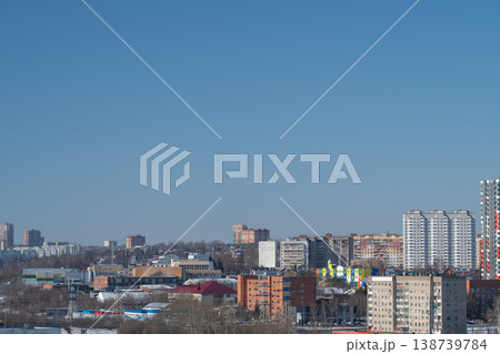 Wide city panorama displaying different rooftops and distant skyscrapers. Extensive suburban urban view showcasing variety of building styles and towering highrise structures 138739784