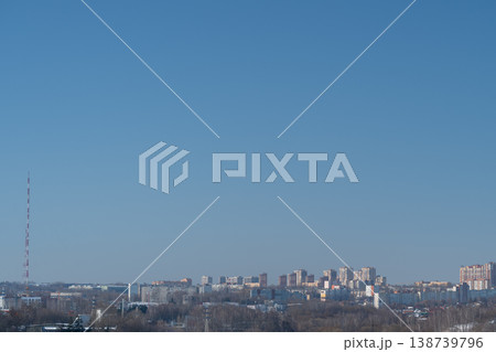 City view panorama. Urban skyline with distant antennas. Tranquil blue sky over cityscape and horizon. Metropolitan scene featuring residential areas and distant skyline City view panorama. Urban skyline with distant antennas. Tranquil blue sky over cityscape and horizon. Metropolitan scene featuring residential areas and distant skyline 138739796