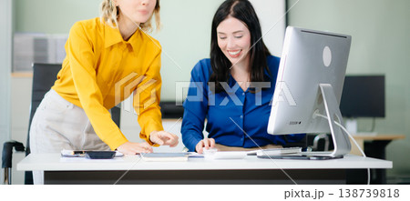 Business colleague business presents and explains and using laptop and tablet. Teamwork, financial Business colleague business presents and explains and using laptop and tablet. Teamwork, financial 138739818