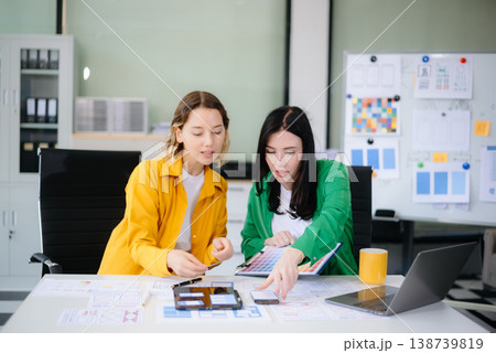 Business colleague business presents and explains and using laptop and tablet. Teamwork, financial Business colleague business presents and explains and using laptop and tablet. Teamwork, financial 138739819
