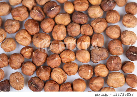 Gourmet product presentation showcasing natural nut aesthetic for branding. Vivid depiction of hazelnut kernels with earthy colors highlighting quality and abundance 138739858