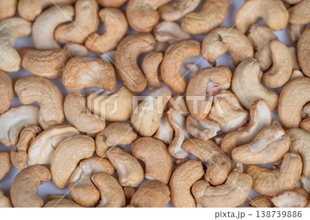 Top view of textured cashew pattern with natural tones. Repeating macro cashew design showcasing organic forms and earthy colors suitable for diverse creative applications Top view of textured cashew pattern with natural tones. Repeating macro cashew design showcasing organic forms and earthy colors suitable for diverse creative applications 138739886