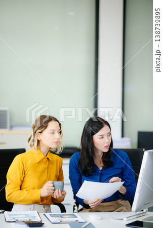 Business colleague business presents and explains and using laptop and tablet. Teamwork, financial Business colleague business presents and explains and using laptop and tablet. Teamwork, financial 138739895