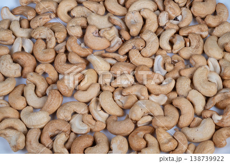 Cashew nuts presentation. Large quantity of natural colored cashew nuts ready for packaging. Spacious view of raw cashew nuts in bulk prepared for commercial packaging Cashew nuts presentation. Large quantity of natural colored cashew nuts ready for packaging. Spacious view of raw cashew nuts in bulk prepared for commercial packaging 138739922