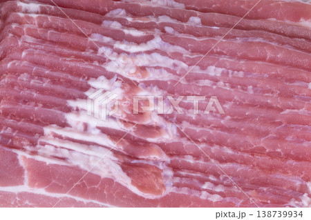 Photographed bacon with marbling. Slices of bacon arranged for visual appeal. Gourmet styled raw bacon slices with marbling used for branding or culinary presentations 138739934