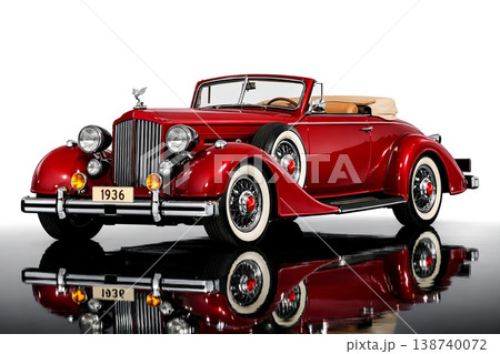 Stunning classic red 1936 vintage convertible car with chrome details and white wall tires, reflecting on a polished surface. A symbol of luxury, elegance, and automotive history 138740072