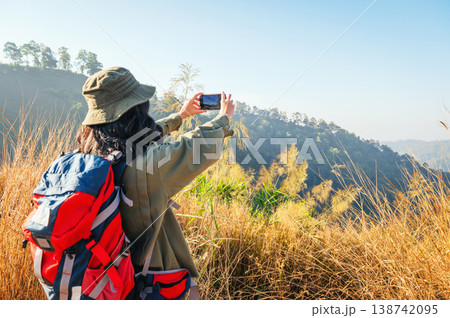 Golden hills stretch behind a hiker Golden hills stretch behind a hiker 138742095