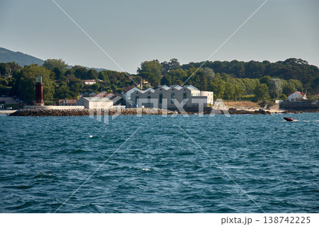 Photograph of the lighthouse next to the Museum do Mar in Vigo with modern design buildings surrounded by trees and the Atlantic coast Photograph of the lighthouse next to the Museum do Mar in Vigo with modern design buildings surrounded by trees and the Atlantic coast 138742225