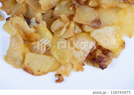 Crispy golden fried potato slices with caramelized edges and crunch. Golden brown fried potato slices with warm crispy surfaces and caramelized edges that enhance flavor Crispy golden fried potato slices with caramelized edges and crunch. Golden brown fried potato slices with warm crispy surfaces and caramelized edges that enhance flavor 138743075