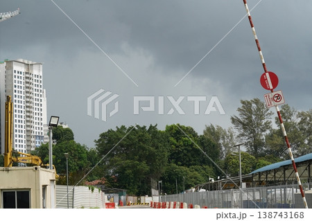 Construction Site with Building and Trees Under Gray Skies Construction Site with Building and Trees Under Gray Skies 138743168