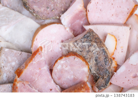 Meat platter presentation. Elegant buffet serving of sliced meats and sausages. Catering tray showcasing neatly sliced and bitesized meat pieces for corporate gatherings Meat platter presentation. Elegant buffet serving of sliced meats and sausages. Catering tray showcasing neatly sliced and bitesized meat pieces for corporate gatherings 138743183
