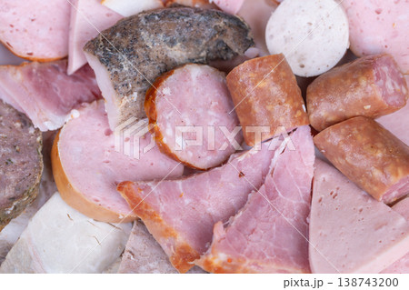 Closeup meat platter on catering tray with neatly arranged sliced ham, rounds of sausage and bologna, professional presentation for corporate event or reception Closeup meat platter on catering tray with neatly arranged sliced ham, rounds of sausage and bologna, professional presentation for corporate event or reception 138743200