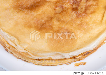 Elegant layers celebrating Maslenitsa. Soft golden with delicate sugar texture. Ultra thin edges of golden with subtle sugar details in plate view Elegant layers celebrating Maslenitsa. Soft golden with delicate sugar texture. Ultra thin edges of golden with subtle sugar details in plate view 138743254