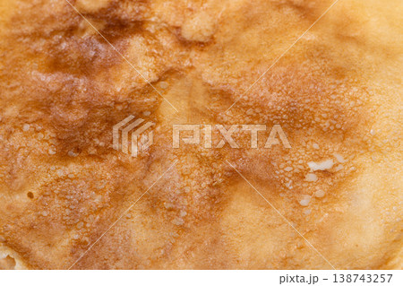 Natural light highlights rough textures of crunchy caramelized surface. Cozy kitchen scene emphasizing irregular caramelization and porous texture of rustic pancakes Natural light highlights rough textures of crunchy caramelized surface. Cozy kitchen scene emphasizing irregular caramelization and porous texture of rustic pancakes 138743257