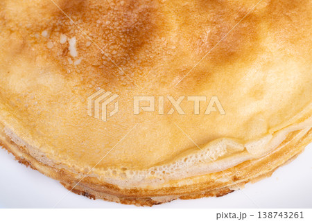 Refined pancake portrayal. Delicate breakfast visual display. Soft textured pancake with subtle color tones. Closeup of airy pancake showing gentle hues and fine textures 138743261