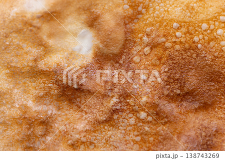 Closeup pancake surface for Maslenitsa showing porous browned bubbles and toasted spots, tactile grain, batter details, inviting crispness for sensory food photography Closeup pancake surface for Maslenitsa showing porous browned bubbles and toasted spots, tactile grain, batter details, inviting crispness for sensory food photography 138743269