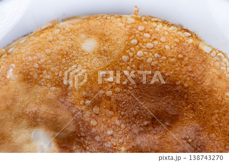 Delicious breakfast imagery. Zoomedin shot revealing textures and warm breakfast ambiance. Intimate perspective highlighting airy bubbles and crispy crust of morning pancake 138743270
