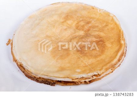 Pancake on plate. Minimalist presentation of single perfectly cooked crepe pancake. Solitary crepe with golden exterior displayed on clean white plate for recipe or menu Pancake on plate. Minimalist presentation of single perfectly cooked crepe pancake. Solitary crepe with golden exterior displayed on clean white plate for recipe or menu 138743283