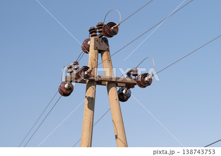 Detailed electrical equipment. Sophisticated array of electrical insulators composed of ceramics and metal parts showcasing industrial craftsmanship and technical intricacy 138743753