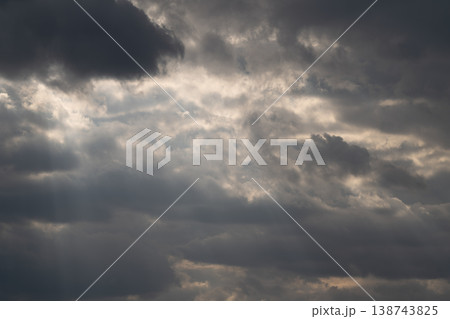 Cinematic clouds with light beams piercing sky, sweeping rays creating crepuscular effect, soft highlights on cloud edges, inspirational mood for film and landscape projects 138743825