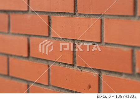 Softfocused portrait backdrop with warm orange brickwork details. Cultivated industrial style wall with blurred edges ideal for advertising and portrait photography 138743833