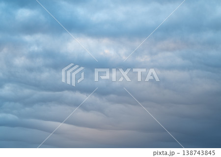 Stratocumulus layers create cool expressive formations. Horizontal bands of stratocumulus clouds evoke cinematic landscape emphasizing atmospheric storytelling and mood Stratocumulus layers create cool expressive formations. Horizontal bands of stratocumulus clouds evoke cinematic landscape emphasizing atmospheric storytelling and mood 138743845